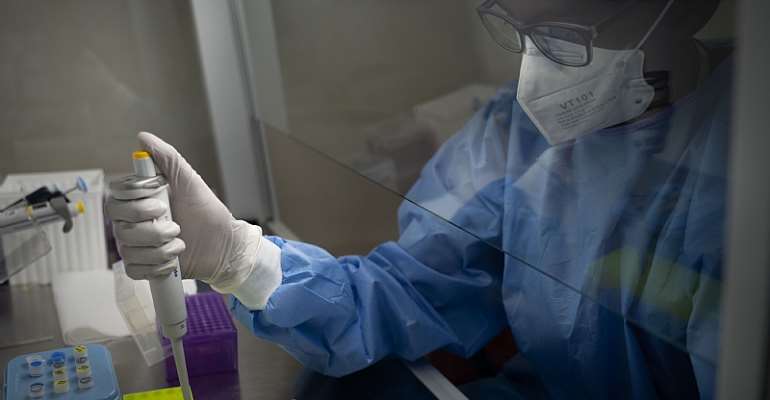 A laboratory technician processes samples for testing COVID-19 at the Rwanda Biomedical Center in Kigali. - Source: Simon Wohlfahrt / AFP via Getty Images