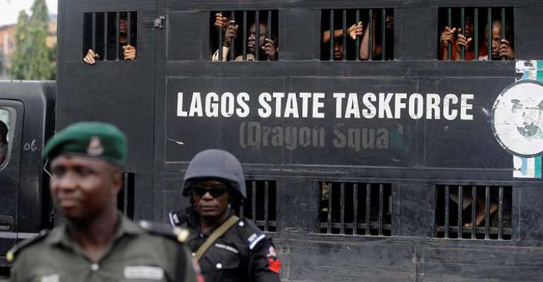 Police officers are seen in Lagos, Nigeria, on August 5, 2019. Lagos police recently arrested publisher Agba Jalingo, who has been charged by federal authorities with treason. (AP/Sunday Alamba)
