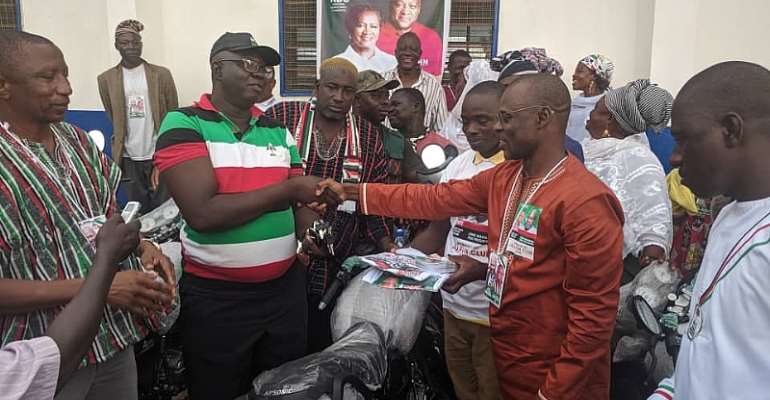 Dr Thomas Anaba presenting the motorbikes and items to the constituency executives and the incumbent MP
