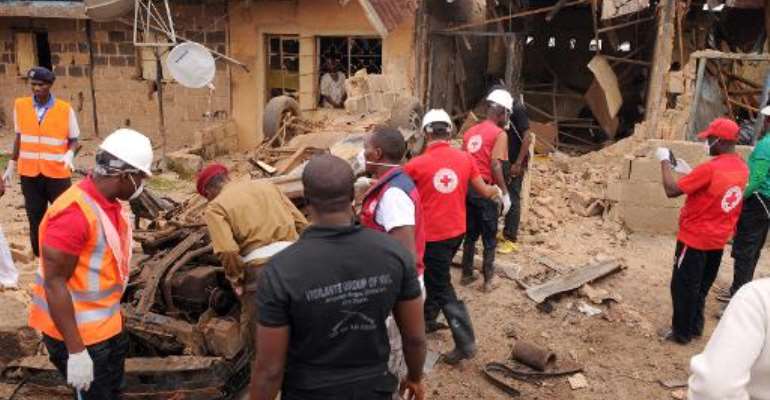 File picture shows emergency response workers at the site of a car bomb blast in the central Nigerian city of Jos, on May 25, 2014. By (AFP/File)