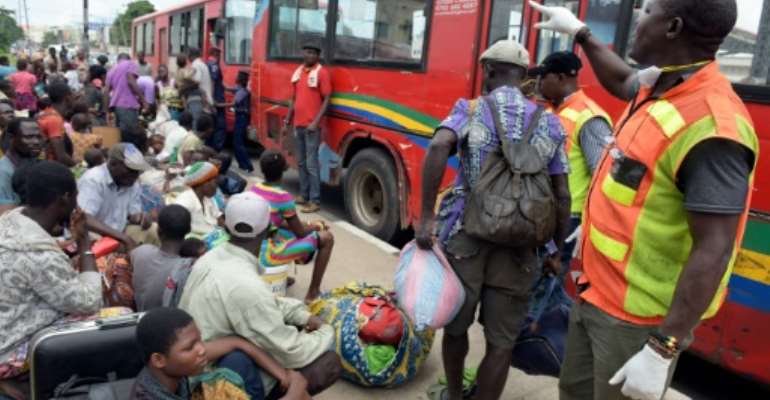 Togolese refugees board buses provided by Lagos State Environmental protection in Lagos, on August 14, 2015. By Pius Utomi Ekpei (AFP)