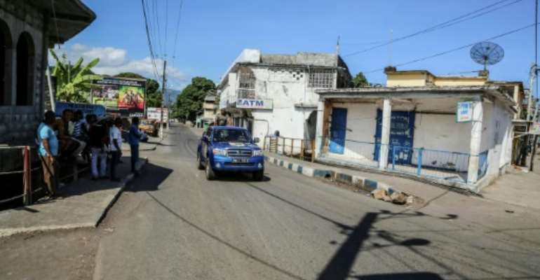 A Comoros police vehicle patrols the tense, deserted streets of Mutsamudu, where rebels oppose President Azali Assoumani's bids to extend term limits through constitutional changes. By YOUSSOUF IBRAHIM (AFP)