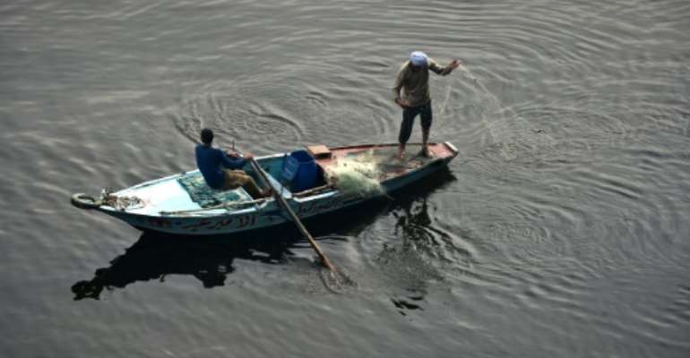 A file pictures shows an Egyptian fishermen throwing a net into the Nile river in Cairo on December 17, 2014. By MOHAMED EL-SHAHED (AFP/File)