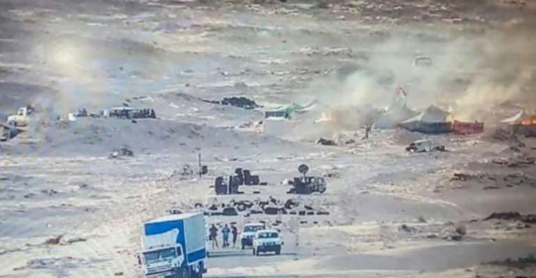 A handout picture published by the Royal Moroccan Army Facebook page on November 13, 2020, shows tents used by the Polisario Front ablaze near the Mauritanian border in Guerguerat after a military operation by Morocco. By - (AFP)