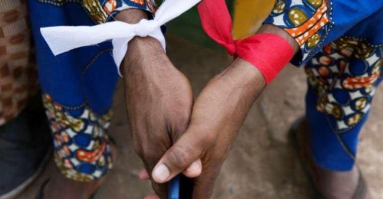 A man wears cloth around his wrists during a demonstration in Bamako on March 15, 2018 organized by Jeunesse Tabital Pulaaku-Mali, the youth chapter of an organization dedicated to preserving the rights of Mali's Fulani people. By Annie RISEMBERG (AFP/File)
