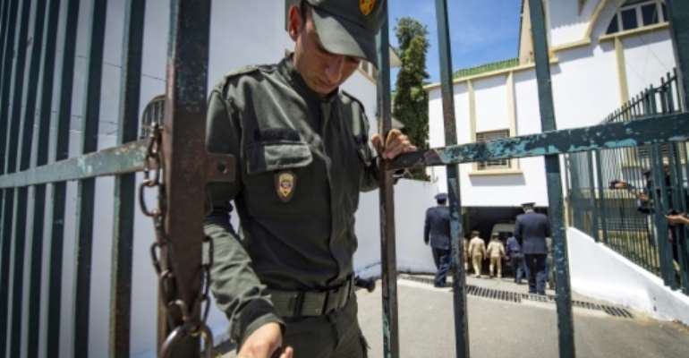 A member of Morocco's security forces locks the entrance to a court in Sale near the capital Rabat in this file picture taken on May 16, 2019. By FADEL SENNA (AFP/File)