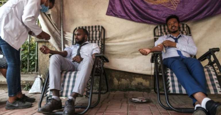 A nurse assists people in Gondar donating blood for Ethiopia's federal forces. By EDUARDO SOTERAS (AFP)