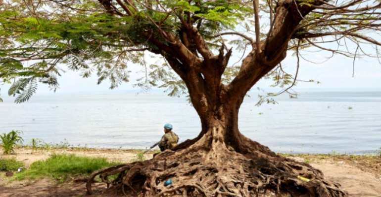 A soldier on guard on Lake Albert where Uganda has jailed 35 DRC nationals for up to three years for illegal fishing. By ALEX MCBRIDE (AFP/File)