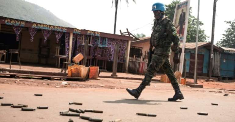 A UN peacekeeper patrols an an area known as PK12 outside Central Africa's Republic's capital Bangui after a rebel attack. By FLORENT VERGNES (AFP)