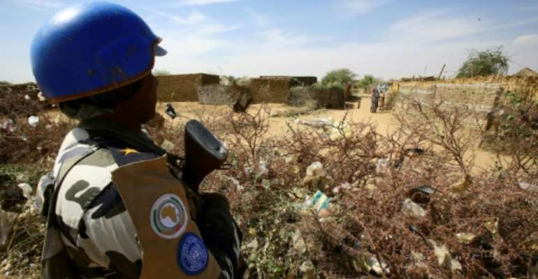 A United Nations peacekeeper stands guard at a UN refugee camp in the city of Nyala, in South Darfur, on January 9, 2017. By Ashraf SHAZLY (AFP/File)