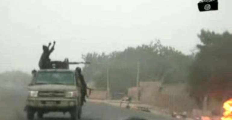 A video released on by Islamist group Boko Haram shows their fighters during a Christmas Day attack on a military checkpoint in Nigeria. By Handout (BOKO HARAM/AFP/File)