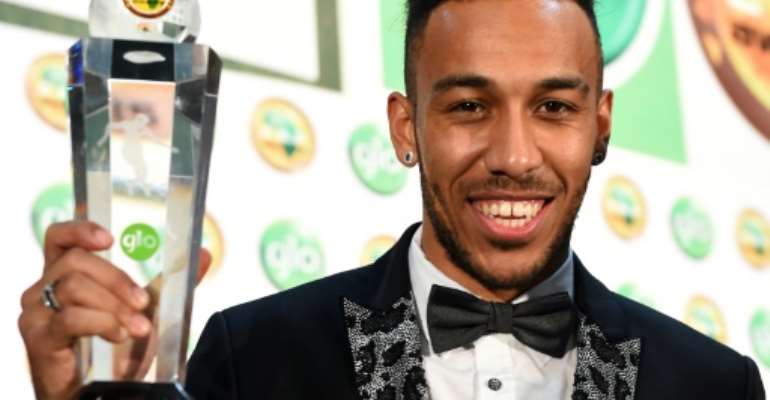 Gabonese striker Pierre-Emerick Aubameyang poses with the African Footballer of the Year award in Abuja, Nigeria, on January 7, 2016. By Pius Utomi Ekpei (AFP)