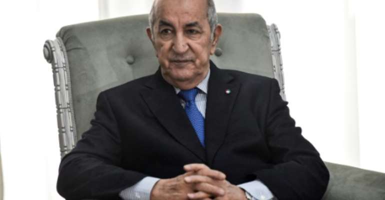Algerian President Abdelmadjid Tebboune, here photographed in January 21, 2020, was transferred from hospital in Algiers to Germany on Wednesday. By RYAD KRAMDI (AFP/File)