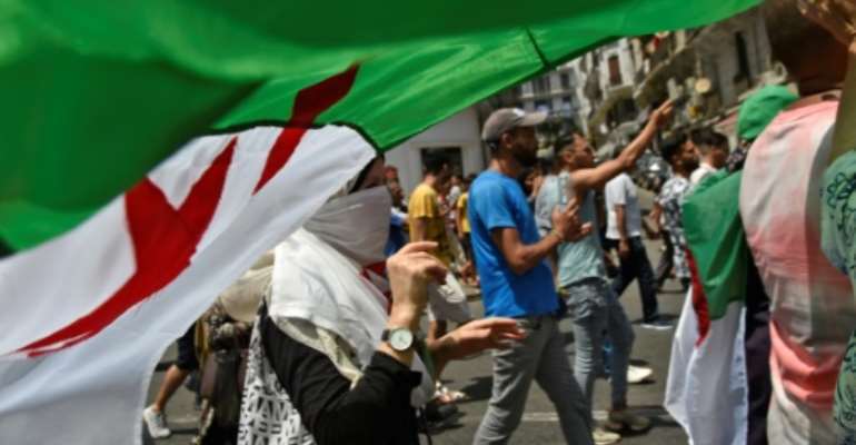 Algerian protesters demonstrate in Algiers calling for an overhaul of the country's political system. By RYAD KRAMDI (AFP)