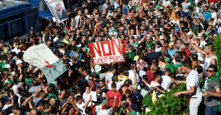 Algerian protesters have continued with their weekly mass demonstrations since President Abdelaziz Bouteflika resigned in April. By RYAD KRAMDI (AFP)