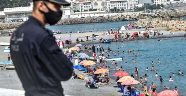 Algerians throng a beach in the Bab el-Oued suburb of the capital Algiers after authorities reopened beaches for the first time following a five-month coronavirus lockdown. By RYAD KRAMDI (AFP)