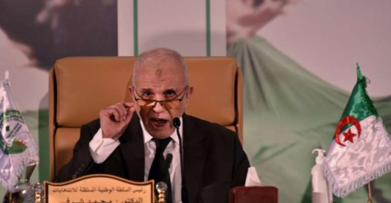 Algeria's electoral authority chief Mohamed Charfi announcing the result of the referendum on Monday. By RYAD KRAMDI (AFP)
