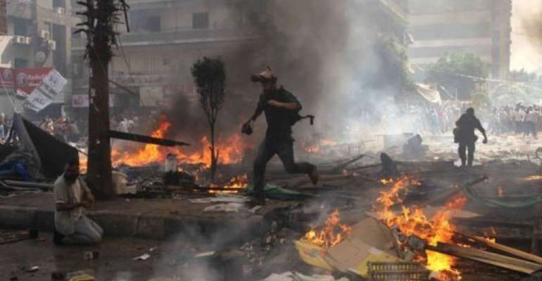 Reporters run for cover during clashes between upporters of Egypt's ousted president Mohamed Morsi, and police in Cairo. By Mosaab el-Shamy (AFP)