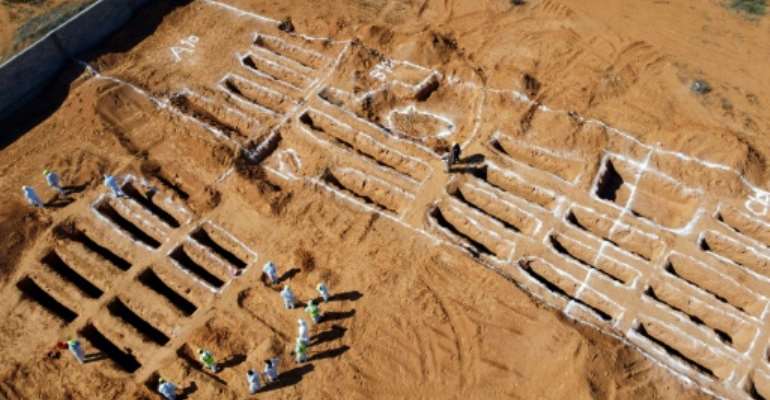 An aerial view shows Libyan experts exhuming human remains from mass graves in Tarhuna, southeast of the capital Tripoli, in this file picture taken on October 28, 2020. By Mahmud TURKIA (AFP/File)