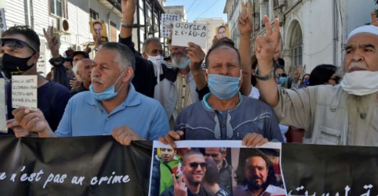 An Algerian demonstrator held up a sign reading in French 'Free the Press' at a protest in the capital Algiers calling for the release of jailed journalist Khaled Drareni in September. By RYAD KRAMDI (AFP/File)