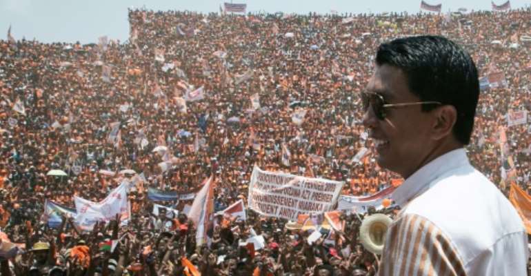 Andry Rajoelina, pictured here at a campaign rally, is ahead in Madagascar's vote count. He is on course for a runoff on December 19 against another former president, Marc Ravalomanana. By RIJASOLO (AFP)