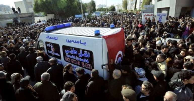 An ambulance takes the body of Chokri Belaid to hospital in Tunis after he was shot dead on February 6, 2013. By Fethi Belaid (AFP)