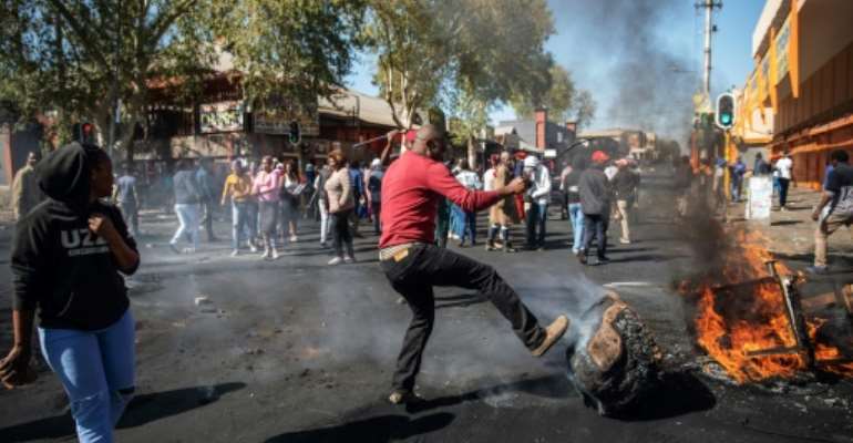 Angry protesters looted alleged foreign-owned shops in Johannesburg in a new wave of violence. By Michele Spatari (AFP)