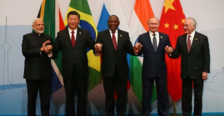 Arm in arm: Indian Prime Minister Narendra Modi, Chinese President Xi Jinping, South African President Cyril Ramaphosa, Russian President Vladimir Putin and President Michel Temer of Brazil. By MIKE HUTCHINGS (POOL/AFP)