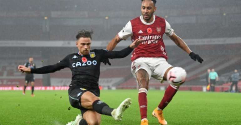 Arsenal forward Pierre-Emerick Aubameyang (R) is thwarted by Aston Villa defender Matty Cash during an English Premier League match in London Sunday.. By Andy Rain (POOL/AFP)