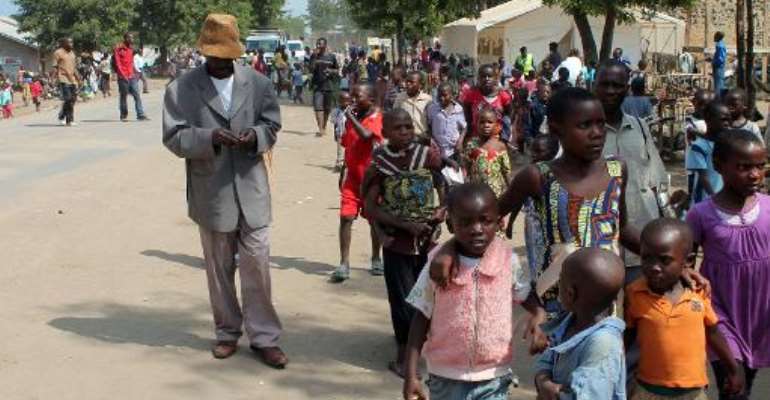 Children leave after the Sunday mass in Kiwanja, 70 km from the eastern Democratic Republic of Congo city of Goma, on March 9, 2014. By Alain Wandimoyi (AFP/File)