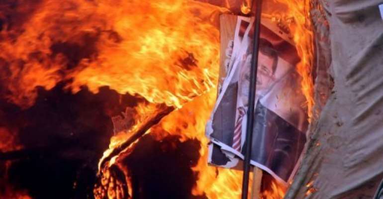 A fire destroys a protest camp after Egyptian police dispersed supporters of Mohamed Morsi from Cairo's al-Nahda Square. By Hassan Mohamed (AFP)