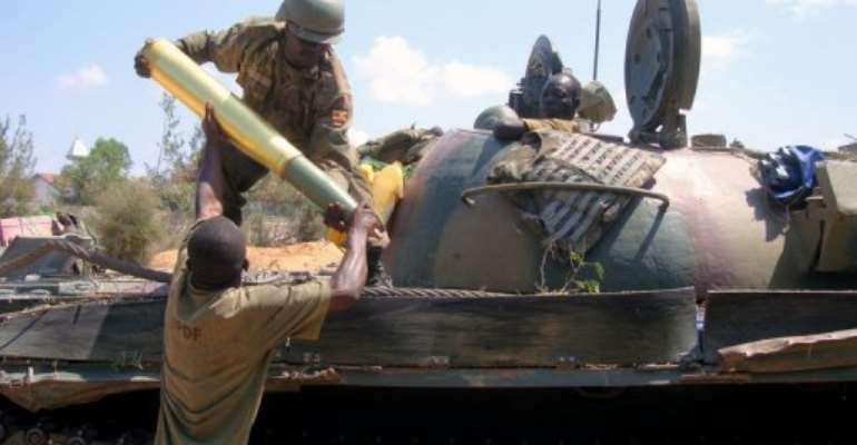 African Union soldiers load a tank shell in Somalia. By Mohamed Abdiwahab (AFP/File)