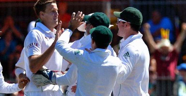 South Africa cricketer Morne Morkel (left) celebrates with teammates after he cleaned bowled Australia's Nathan Lyon, during their second Test in Port Elizabeth on February 22, 2014. By Alexander Joe (AFP)
