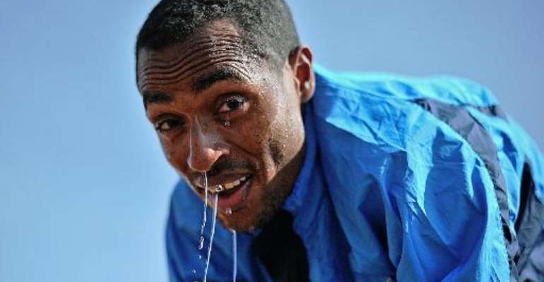 Ethiopia's long distance runner Kenenisa Bekele takes a break at his training grounds in Sululta near Addis Ababa, on January 16, 2014. By Carl de Souza (AFP)