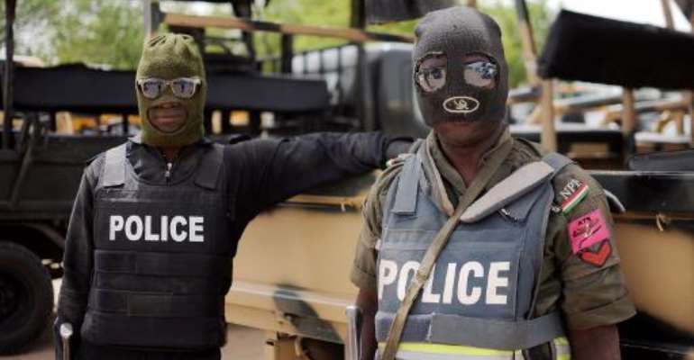 Nigerian police pose for a photo prior to going on patrol in the former Boko Haram headquarters in Maiduguri on June 5, 2013. By Quentin Leboucher (AFP/File)
