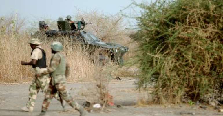 Soldiers on patrol close to a former Boko Haram camp near Maiduguri, northeast Nigeria on June 5, 2013. By Quentin Leboucher (AFP/File)