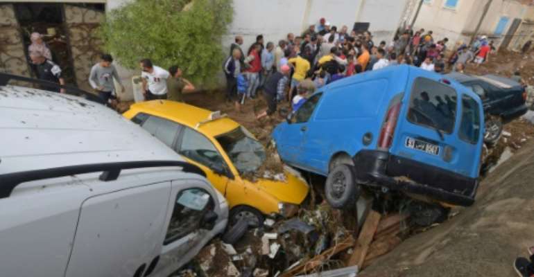 Cars piled up in a street after they were hit by flash floods in the city of Mohamedia near Tunisia's capital Tunis on October 18, 2018. By FETHI BELAID (AFP)