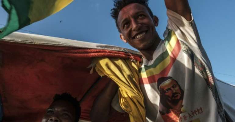 Celebrations: A man waves the Ethiopian imperial flag during an impromptu parade for freed opposition leaders in Alamata. By EDUARDO SOTERAS (AFP)