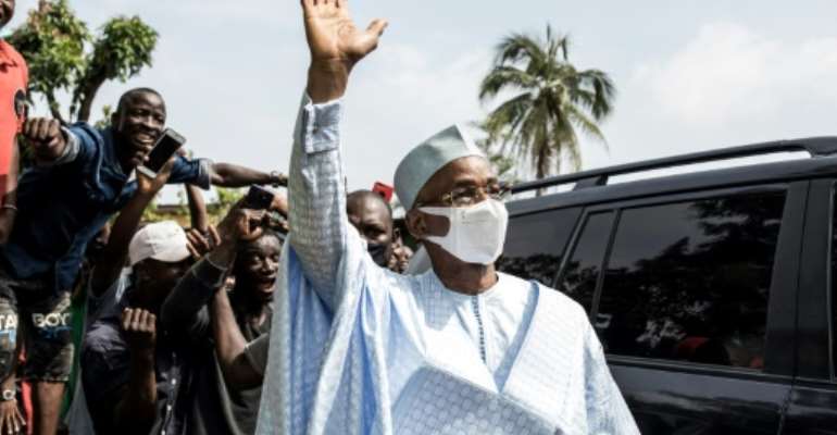 Cellou Dalein Diallo waves at supporters in Conakry in October 2020. By JOHN WESSELS (AFP/File)