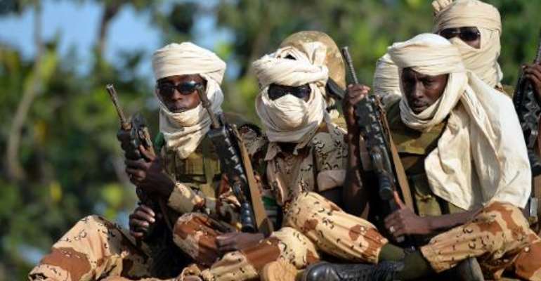 Chadian soldiers sit in a pickup truck as they leave Bangui on April 4, 2014. By Miguel Medina (AFP)