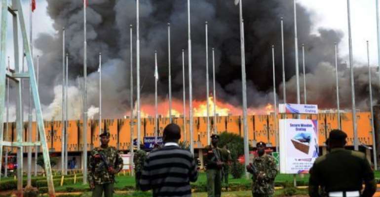 General Service (GSU) officers outside the burning Jomo Kenyatta international airport in Nairobi on August 7, 2013. By (AFP)