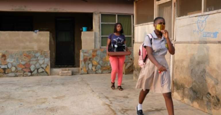 Cindy Anyetei, 13, heads out for her school in Accra. Classes were shut for 10 months because of coronavirus.. By Nipah Dennis (AFP)