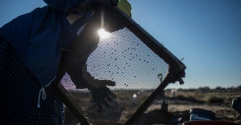 Clara Maitse is one of hundreds of small-scale miners to have received licences to operate on a vast tract of land near Kimberley in the country's centre. By MUJAHID SAFODIEN (AFP)