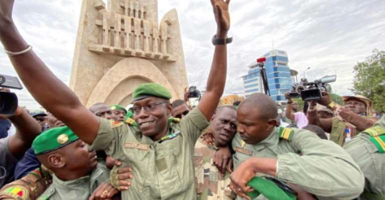 Col. Malick Diaw, deputy head of the new junta, greeted the crowd celebrating in Bamako's Independence Square. By MALIK KONATE (AFP)