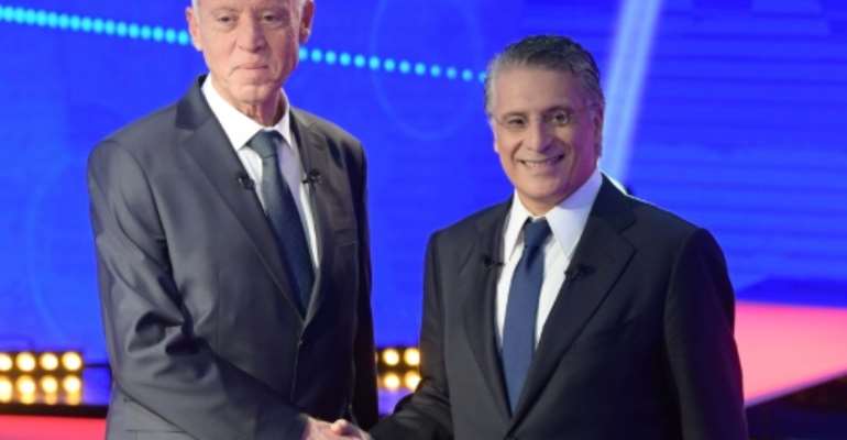 Conservative law professor Kais Saied (L) and business tycoon Nabil Karoui (R) are going head-to-head in Tunisia's runoff presidential election. By Fethi Belaid (AFP)