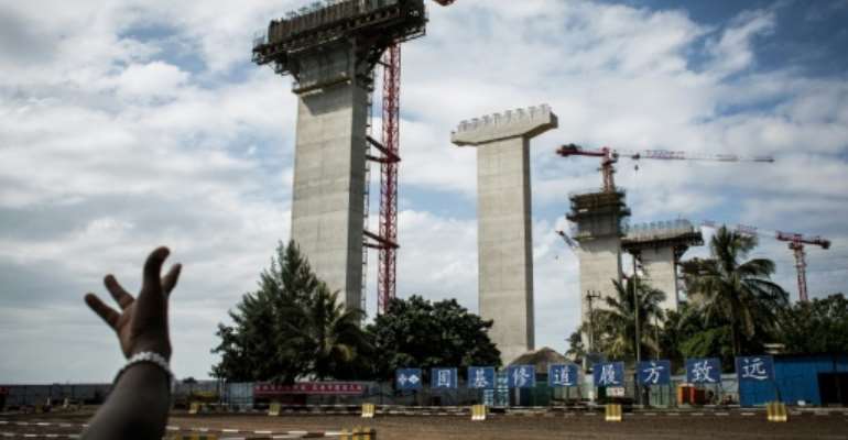 Construction work on the Chinese-built Maputo-Katembe Bridge, linking the two sides of the bay of Mozambique's capital. The three-kilometer, $725-million structure, scheduled to open this year, will be Africa's longest suspension bridge. By JOHN WESSELS (AFP)