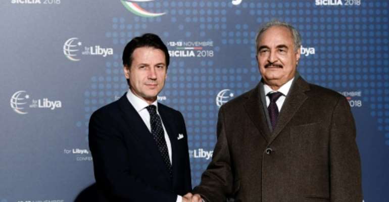 Conte (L) greeted Haftar upon his arrival in Palermo for the conference. By Filippo MONTEFORTE (AFP)
