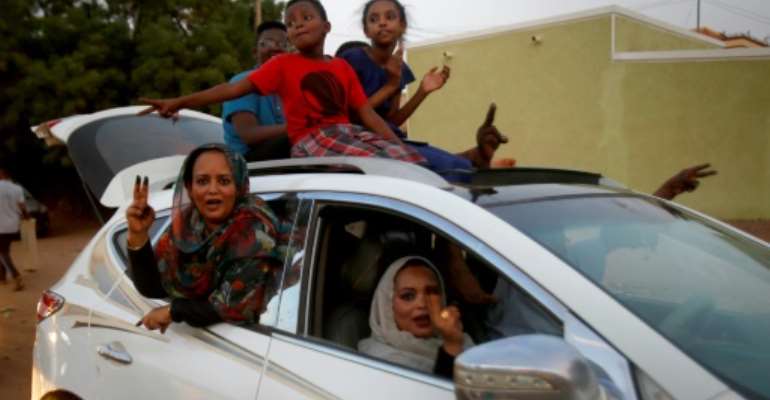Convoys of vehicles honking horns took to the streets of Khartoum as Sudanese celebrated a hard-won deal between protest leaders and the ruling generals aimed at drawing the line under months of political unrest. By ASHRAF SHAZLY (AFP)