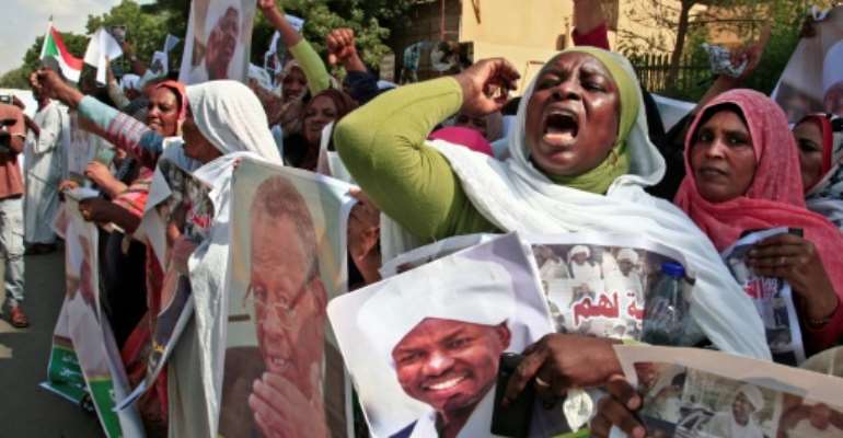 Demonstrators carried Sudanese flags and photographs of detained former regime officials, calling for their release. By Ebrahim HAMID (AFP)