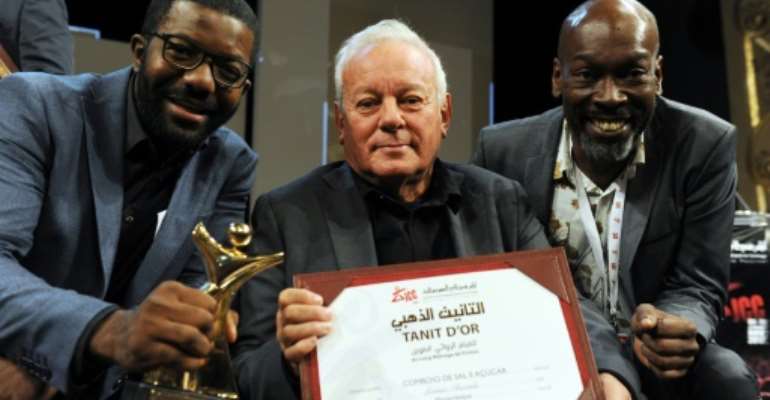 Director Licinio Azevedo (C), flanked by actors Matamba Joaquim (L) and Thiago Justino, poses after receiving the Tanit d'Or award for his film